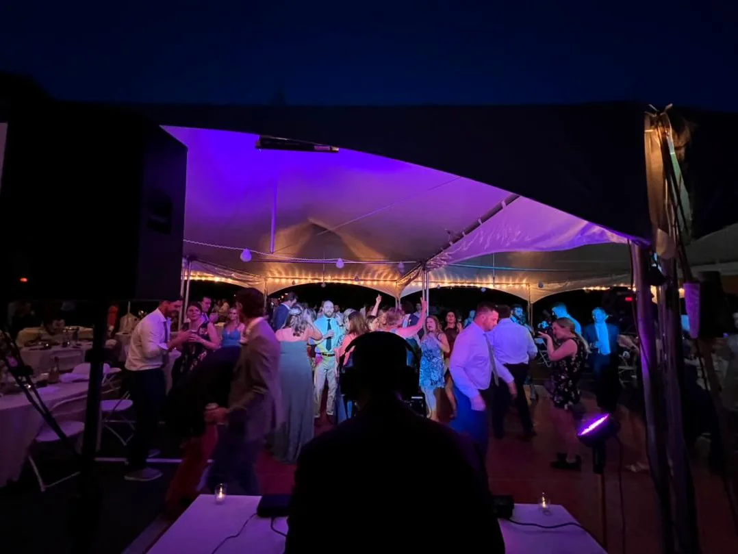 A packed dance floor lit in purple at an ItsTheDro event