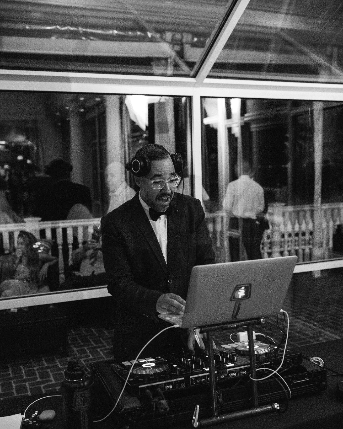 Pedro working behind the decks, photographed in black and white