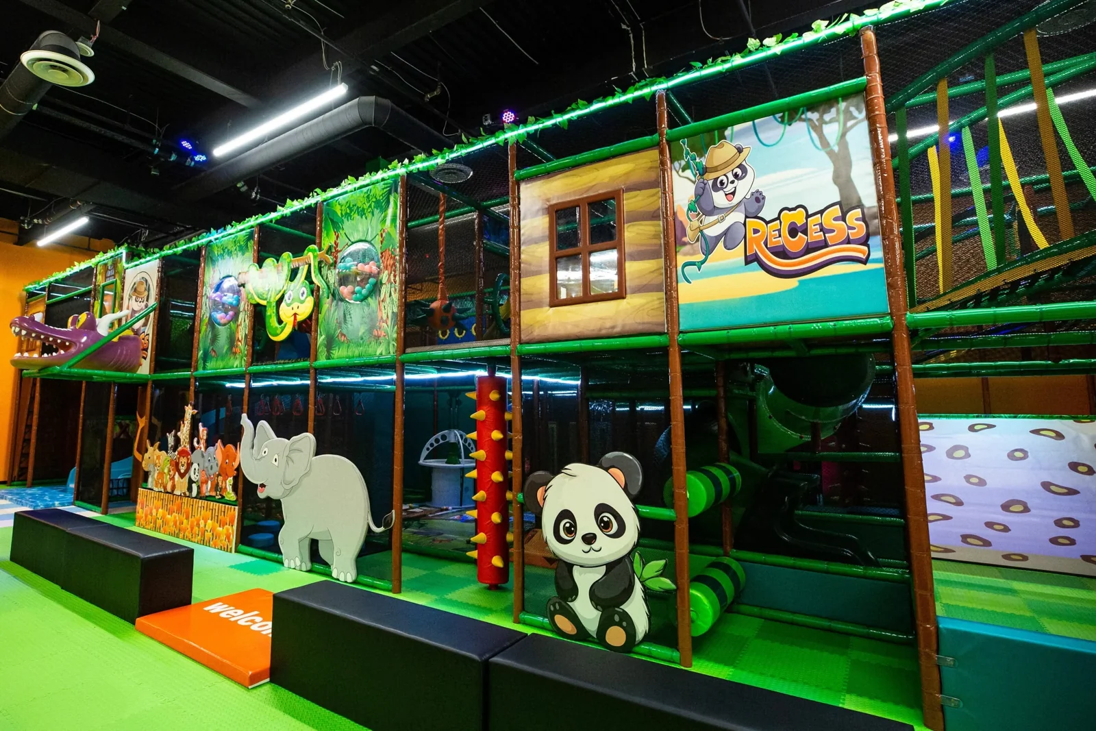 The hand-painted jungle walls and climbing structure at Recess